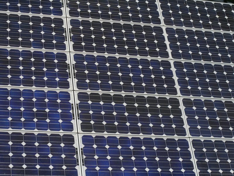 Rows of deep blue solar cells on a clean photovoltaic panel